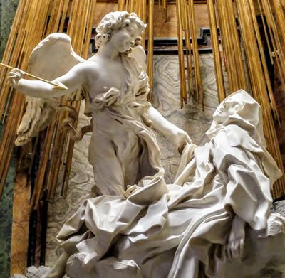 The Ecstasy of St Teresa by Bernini. Here she is in full regalia with a piercing arrow enjoying sublime orgasmic glory. 